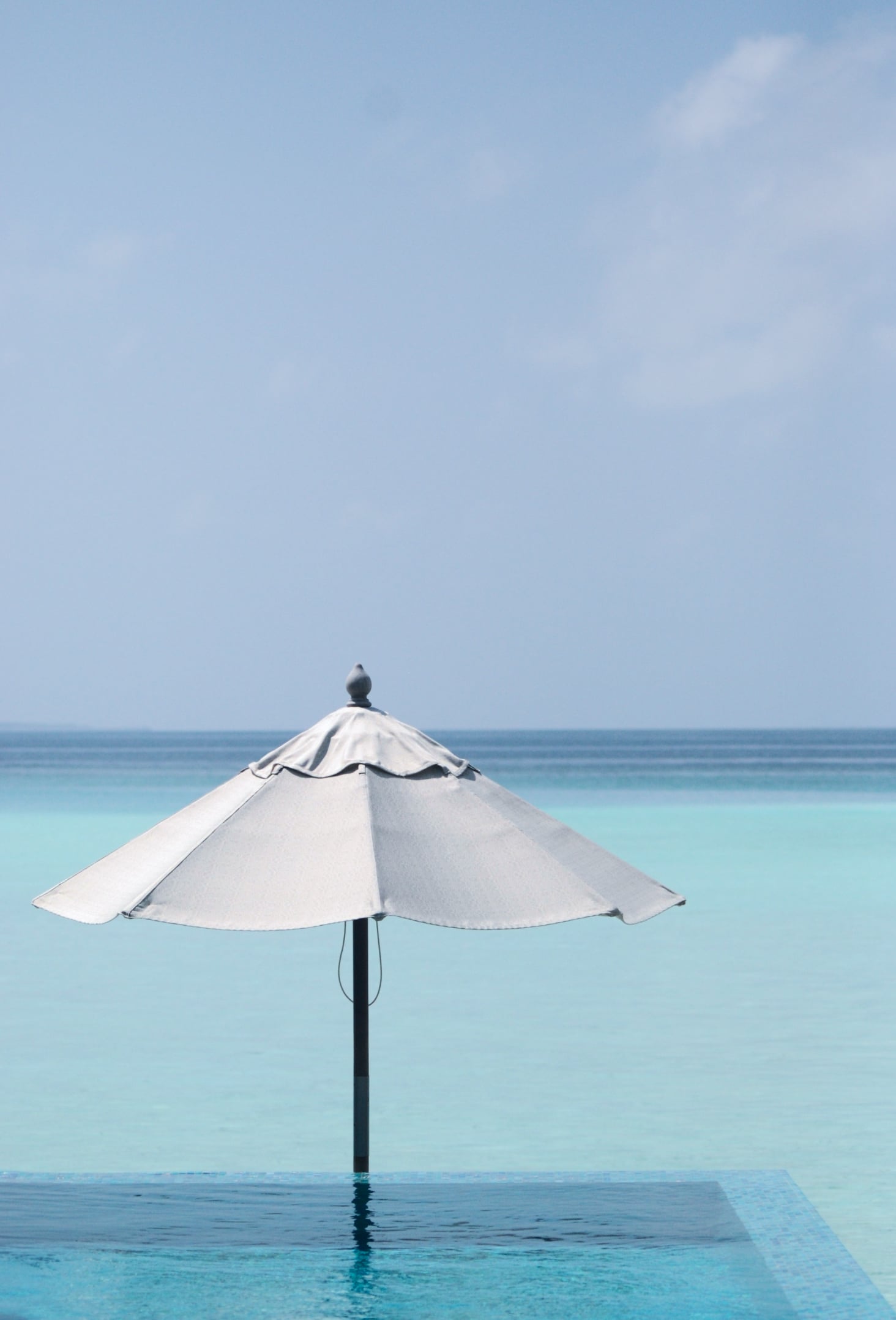A beach umbrella in front of the sea